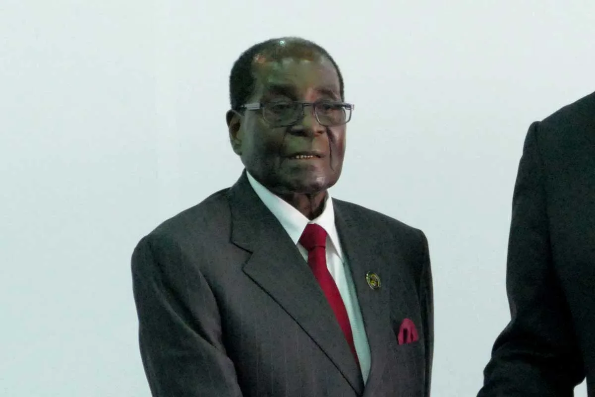 Documents suggest BAT bribed Zimbabwe's dictator Robert Mugabe, pictured in a grey suit and red tie