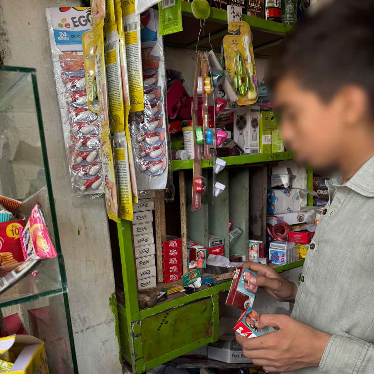 A boy in Pakistan examines cigarette packs placed within children's reach.