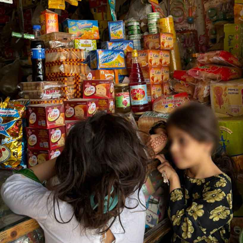 Nicotine pouches are stacked on top of cakes that are popular with children in Pakistan.